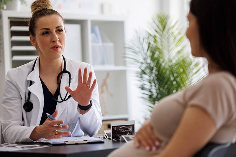 obgyn-doctor-talking-to-pregnant-woman-about-postpartum-pelvic-floor-health